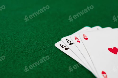 Preview: High angle shot of playing cards on a green table
