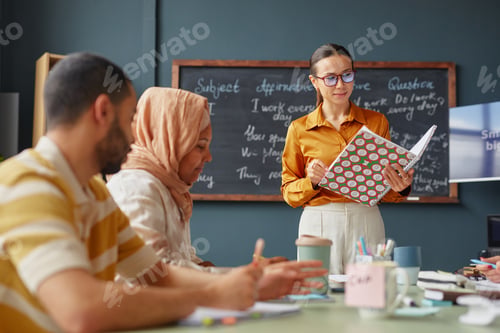 Preview: Young Caucasian Woman Teaching Multiethnic Adults during Language School Lesson