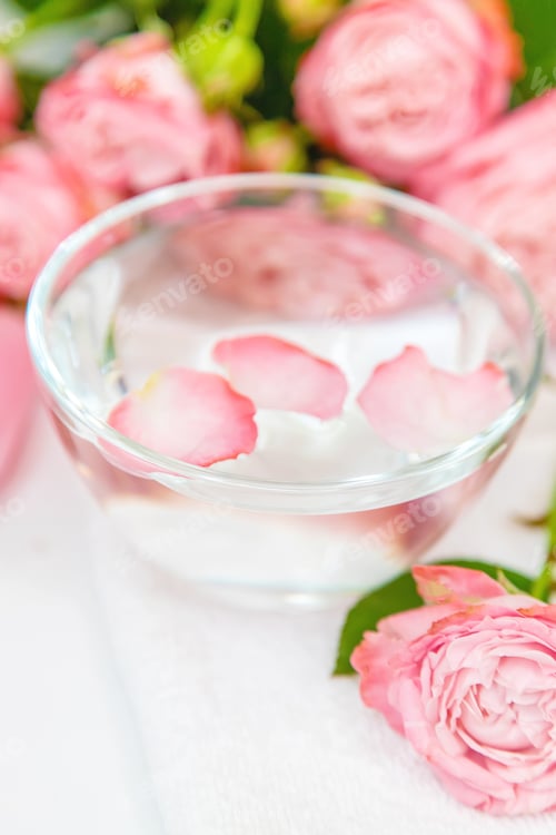 Pink Rose Petals Float in Clear Glass Bowl