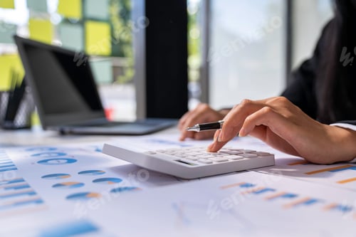 Preview: The hand of Asian woman is pressing calculator and prepare information for report to correct. While