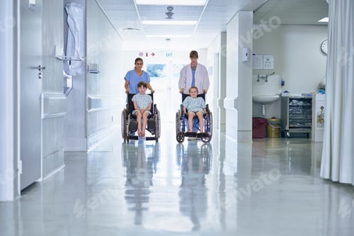 Preview: Medical orderly pushing boy patients in wheelchair on hospital children's ward
