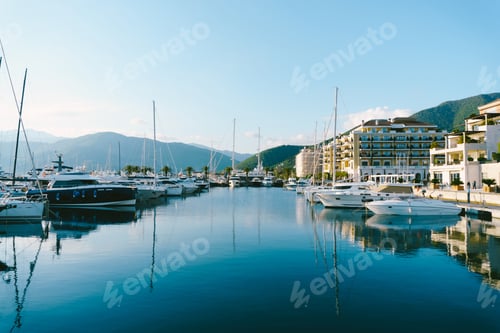Preview: Yachts at the pier against the backdrop of coastal hotels in Porto Montenegro