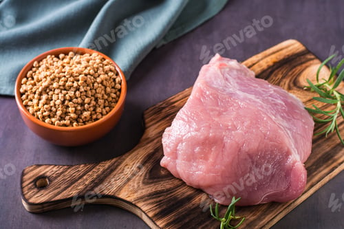 Preview: A piece of fresh meat on a cutting board and soy mince in a bowl on the table