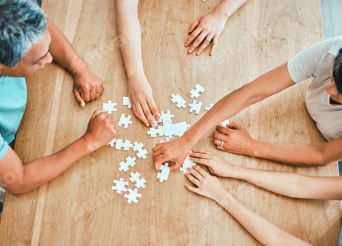 Preview: We have all the pieces. Shot of a family building a puzzle together at home.