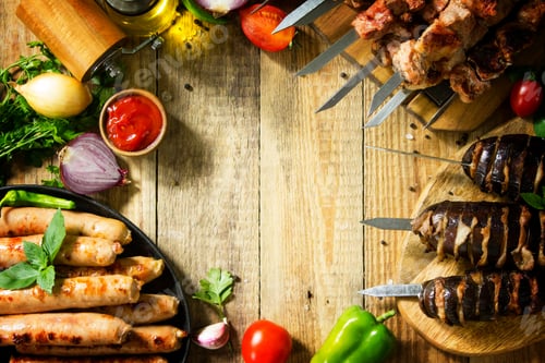 Preview: Grilled meat skewers, grilled sausages and grilled eggplant with bacon on rustic wooden table.