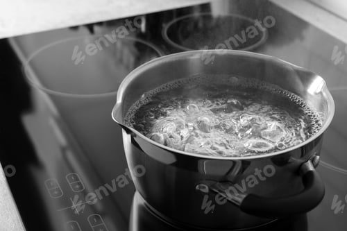 Preview: Pot with boiling water on electric stove, space for text