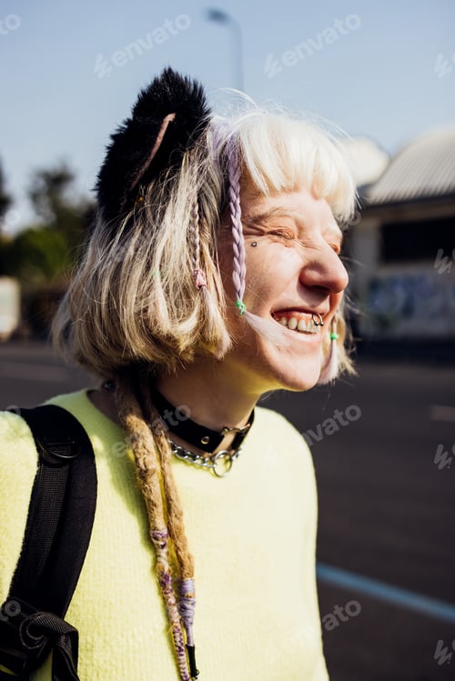 Preview: Portrait smiling young diverse gender fluid pierced woman outdoor laughing