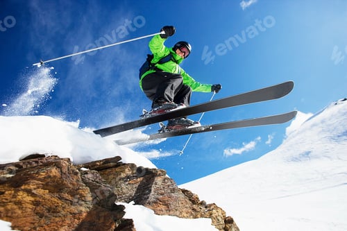 Preview: Male skier jumping at speed down mountain