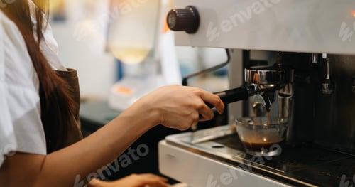Preview: Cup and professional espresso machine pouring fresh coffee into a glass cup at cafe