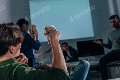 Preview: cropped image of people in office at nighttime with coffee cups