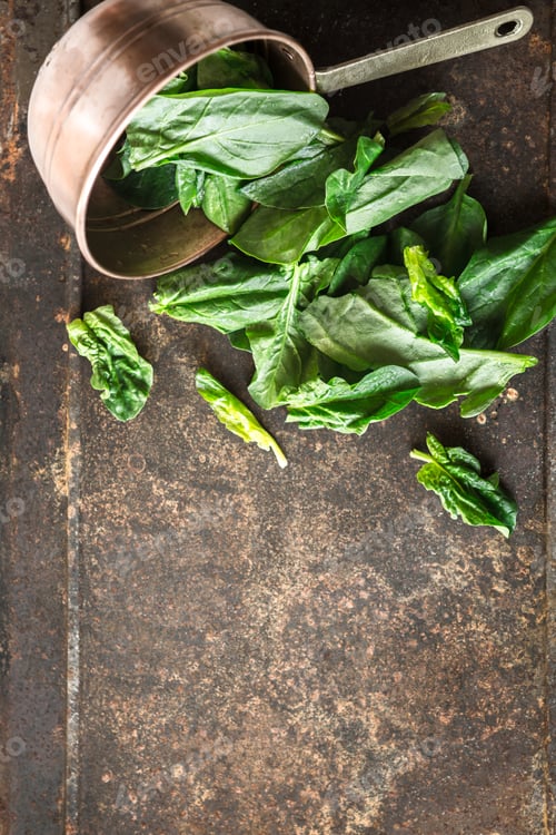 Preview: Spinach in the copper pt on the metal background vertical