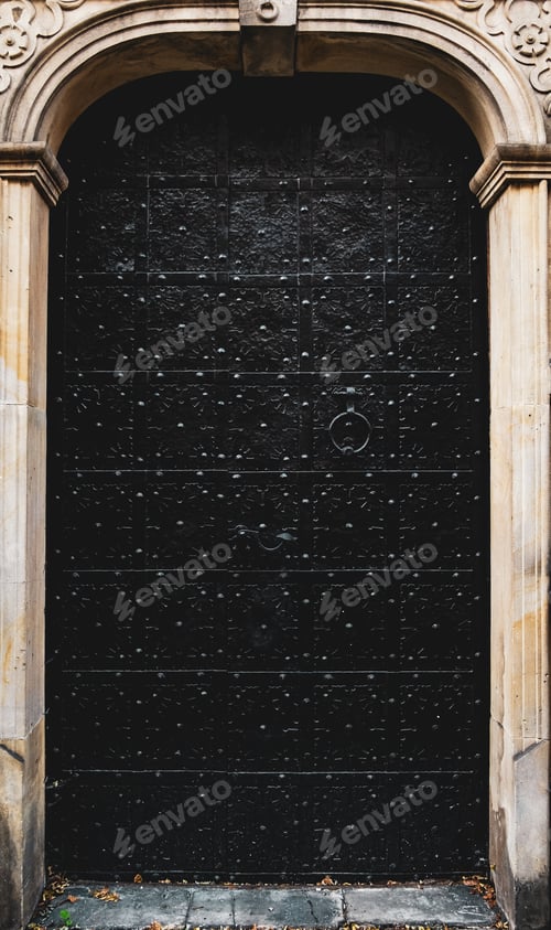 Preview: Old vintage black heavy metal door. Mysterious door to a dungeon or castle.