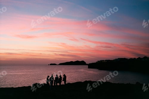 Preview: Group of young people come together at sunset to have fun on the beach