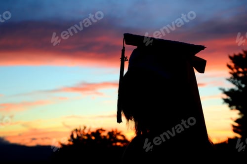 Preview: Silhouette of a person in a graduation cap with a tassel against a sunset sky