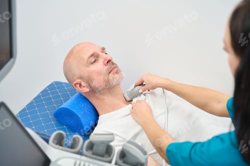 Preview: Professional health worker measures work of heart to a man