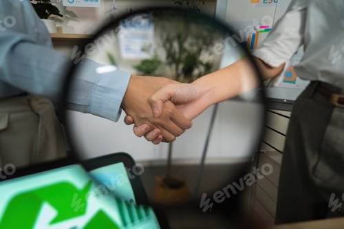 Preview: ESG Partnership. Close-up of a handshake symbolizing collaboration in sustainability efforts.