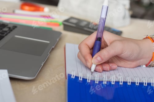 Preview: Student writing in notebook