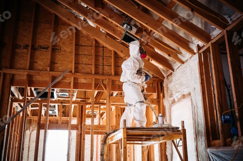 Preview: Man in a special white uniform with a mask repairs the wooden roof of a huge building