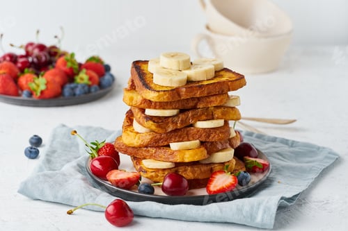 Preview: French toasts with berries and banana, brioche breakfast, white background, closeup