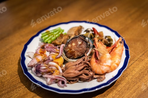 Preview: People Eat Plate Of Seafood On Table In A Restaurant