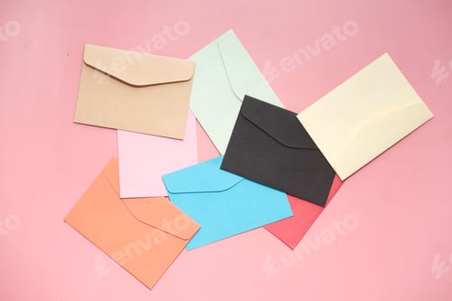 Preview: close up of colorful envelopes pink background