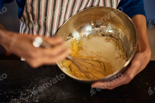 Preview: Close-up photo of a mature female cook, making something sweet for her grandchildren.
