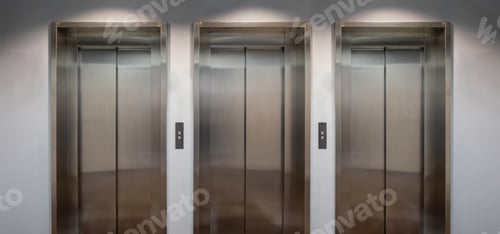Preview: Elevators lobby, Stainless steel lifts with closed doors front view.