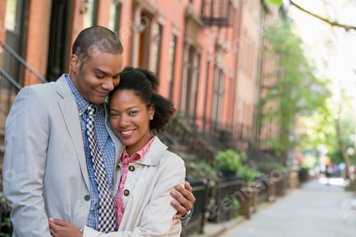Preview: A couple standing side by side on a city street.