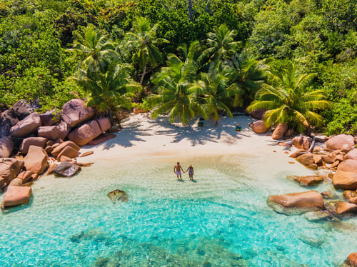 Preview: Praslin Seychelles tropical island with withe beaches and palm trees, couple men and women mid age