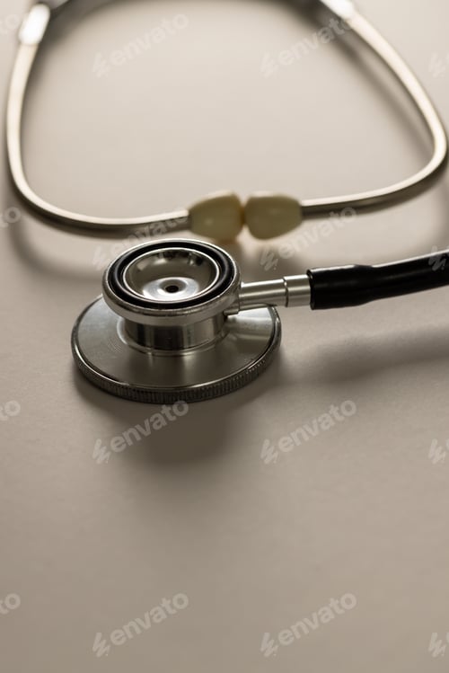 Preview: Vertical composition of stethoscope on white surface with shadows, copy space