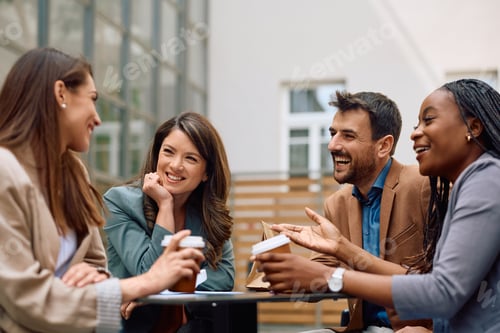 Preview: Cheerful start up team communicating during coffee break on a terrace.