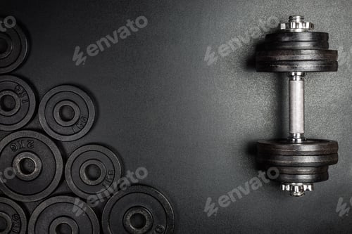 Preview: Gym dumbbells with black metal weights 1kg and 2kg on black background with copy sapce