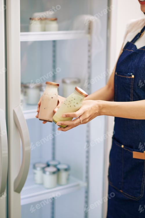 Preview: Shop assistant offering fresh yogurt