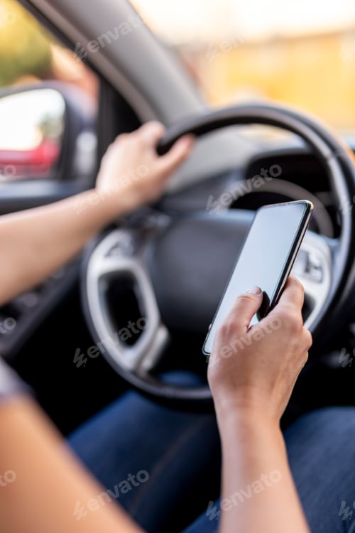Preview: Woman driving a car and using a phone