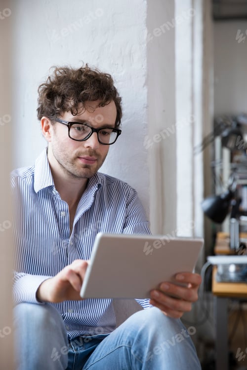 Preview: Man using tablet in office