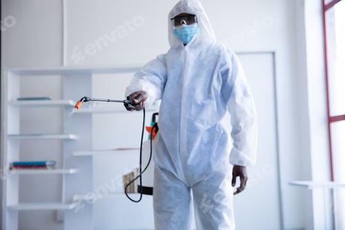 Preview: Health worker wearing protective clothes cleaning using disinfectant