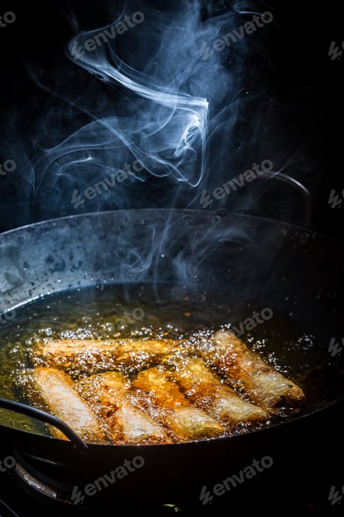 Preview: Homemade spring rolls frying in black wok
