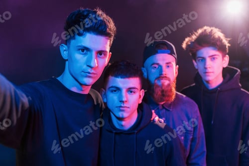 Preview: Taking selfie. Group of people is together in the studio with futuristic neon lighting