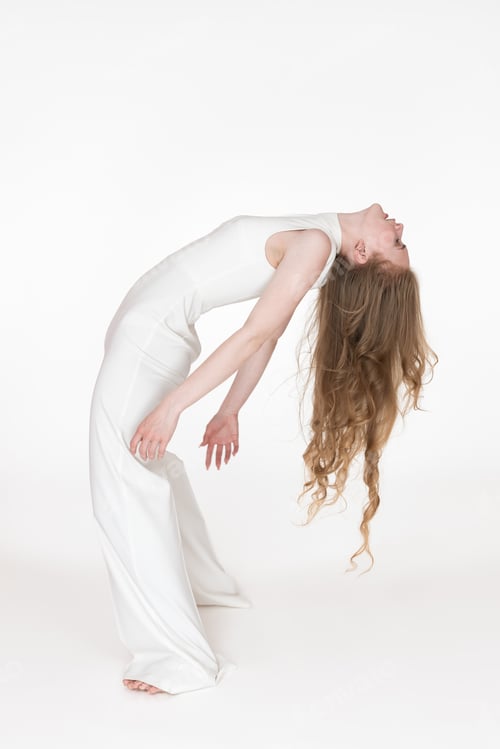 Preview: Flexible young blonde woman dancer with eyes closed bending over backwards. Full length, side view
