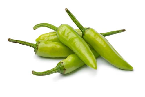 Preview: Heap of whole fresh raw green rawit peppers close up on white background