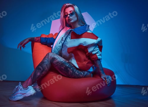Preview: Blond woman is sitting on bean bag