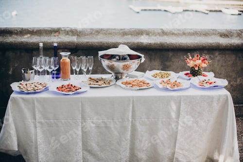 Preview: Delicious italian appetizers on table at wedding reception outdoors
