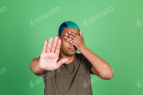 Preview: African man in casual on green background cover his eyes with hands showing stop gesture