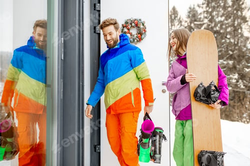 Preview: Couple in ski suits coming home in the mountains