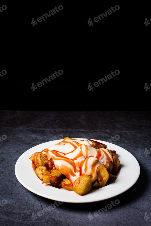Preview: High angle shot of potatoes with brava or spicy sauce