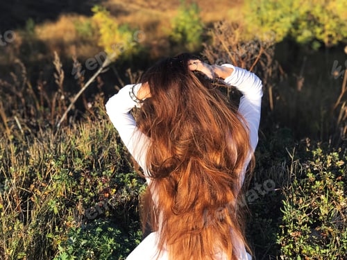 Preview: Woman with Long Hair Poses Outdoors in Field