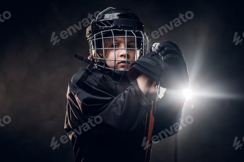 Preview: Young hockey player posing in uniform for a photoshoot in a studio