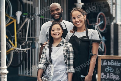 Preview: Portrait of three young colleagues standing outside their bicycle repair shop