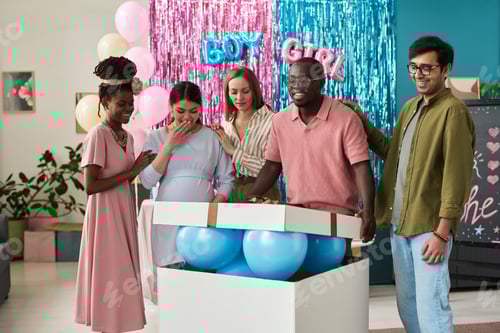 Preview: Group of young adult multiethnic friends standing around large box with blue balloons