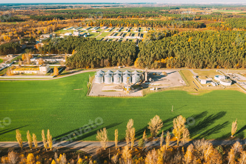 Preview: Aerial view modern granary, grain-drying complex, commercial grain or seed silos in sunny autumn
